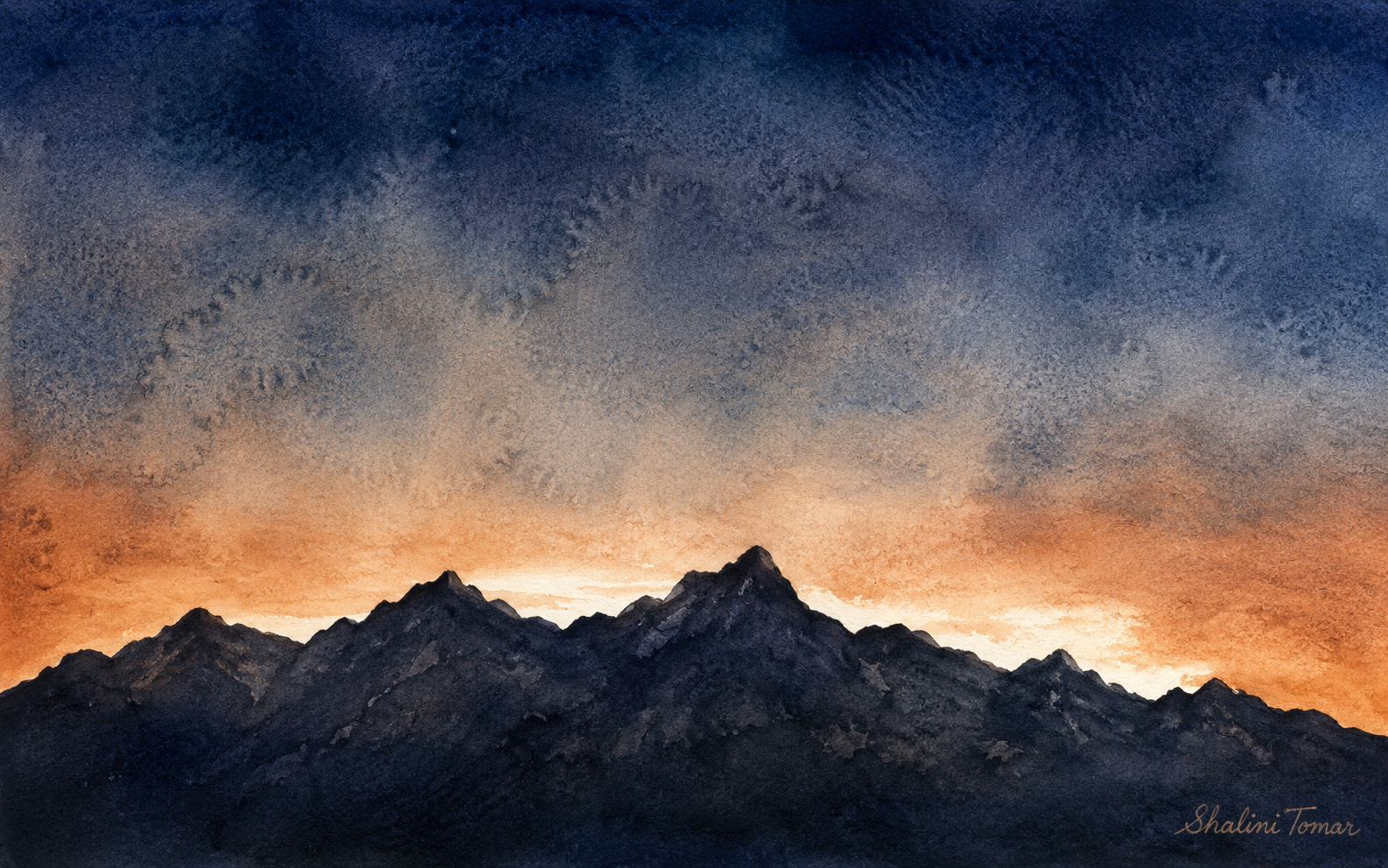 Jagged indigo mountains beneath an amber dawn band and stormy blue watercolor sky