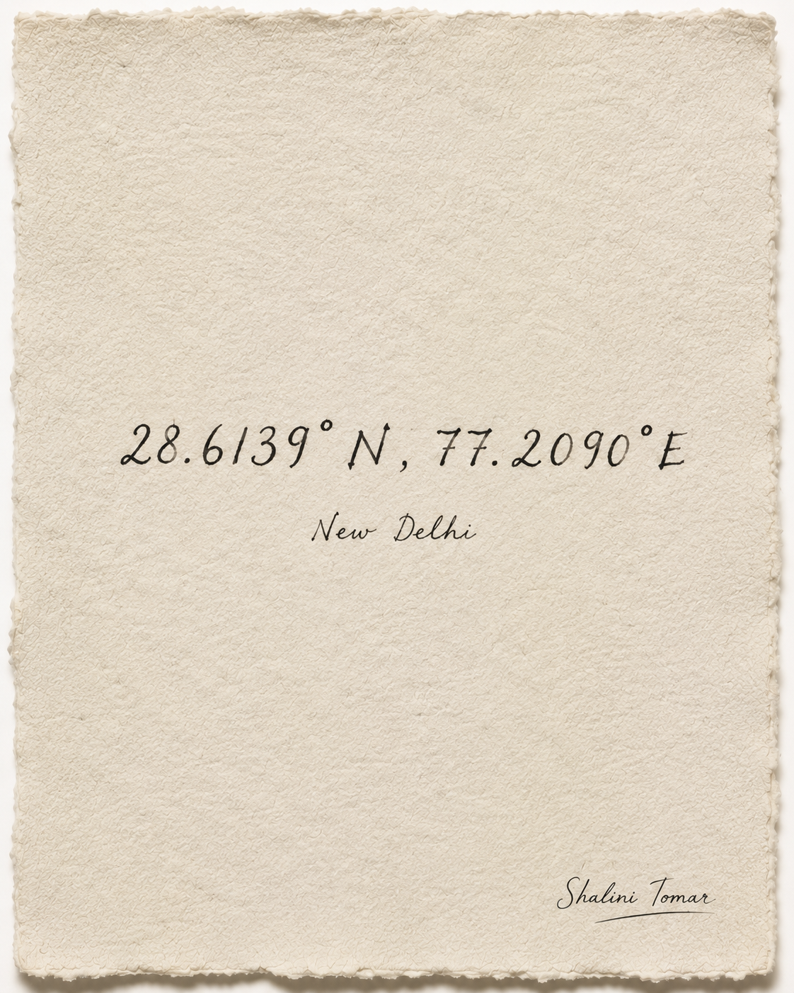 Hand-lettered New Delhi coordinates, 28.6139° N, 77.2090° E, on softly textured ivory paper