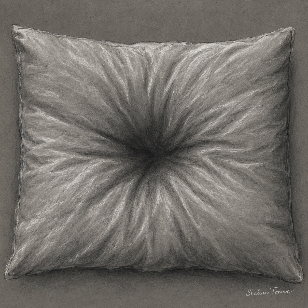 Charcoal-gray pillow with a deep central impression and radiating creases