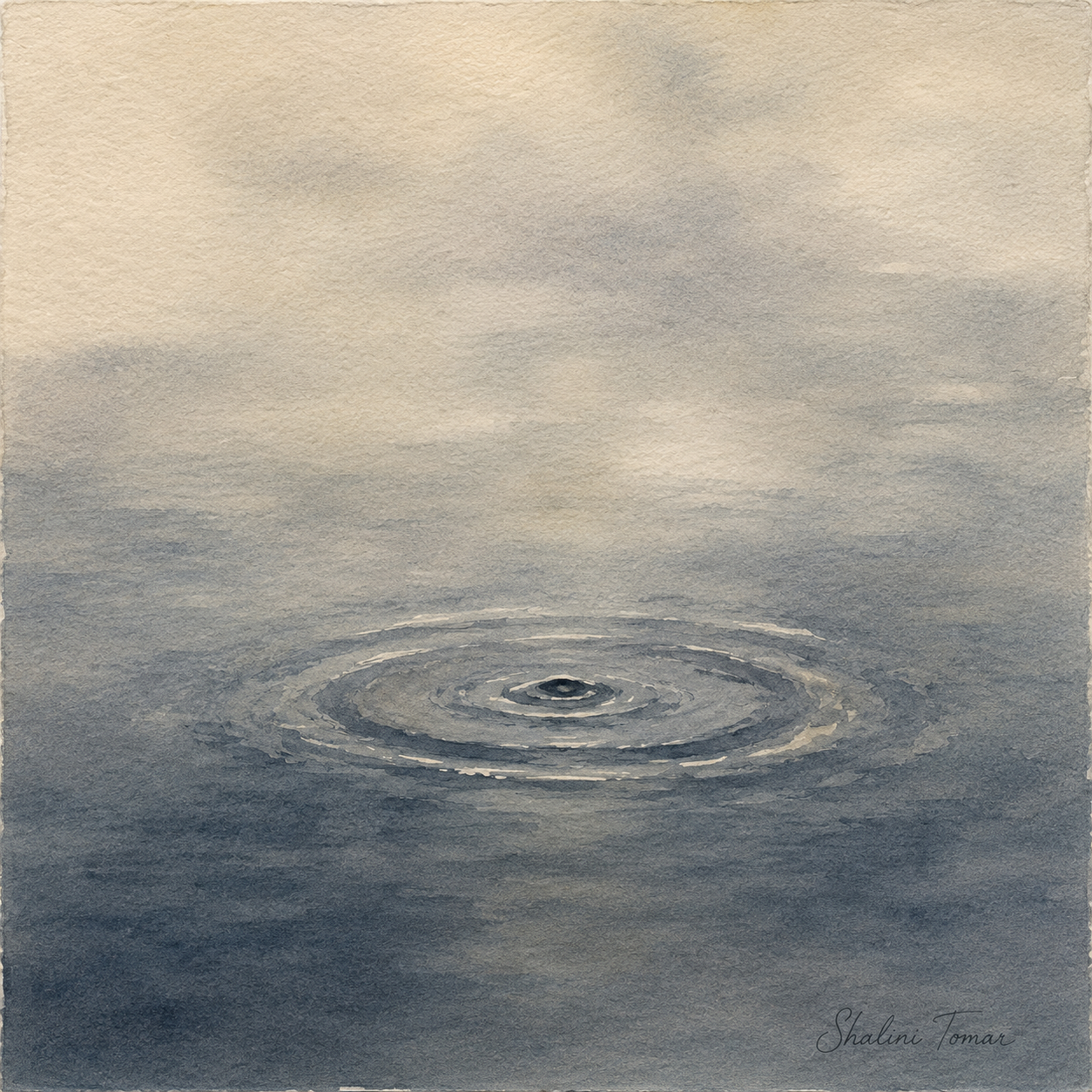 Blue-gray concentric ripples spread across still water beneath a hazy horizon.